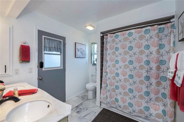 bathroom featuring a sink, toilet, marble finish floor, and double vanity