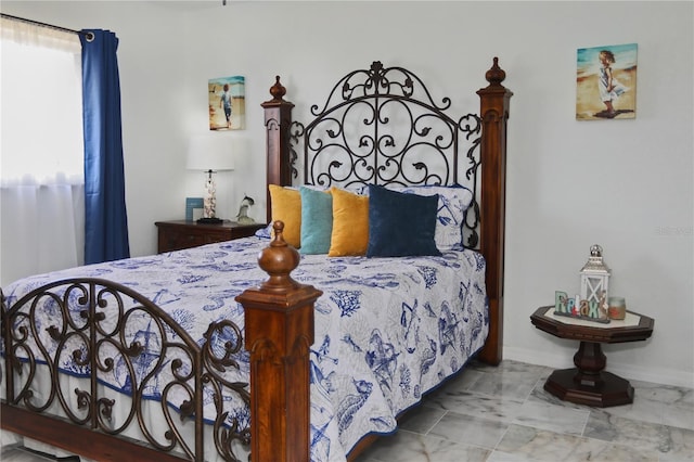 bedroom featuring baseboards and marble finish floor