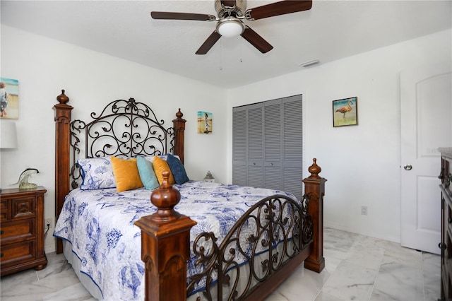 bedroom featuring a closet, marble finish floor, a ceiling fan, and visible vents