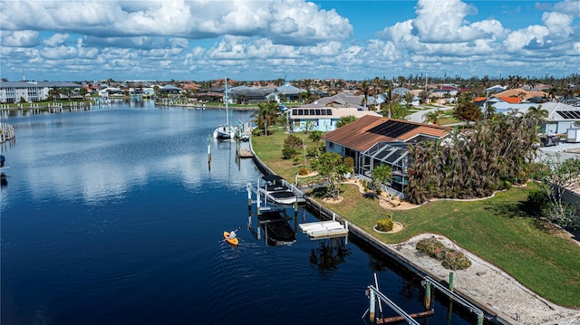 drone / aerial view featuring a residential view and a water view