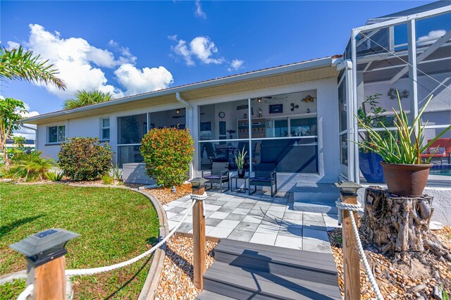 exterior space with stucco siding, a patio, a lanai, and a front lawn