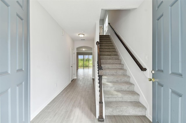 staircase featuring hardwood / wood-style flooring