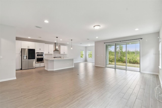 unfurnished living room with light hardwood / wood-style flooring