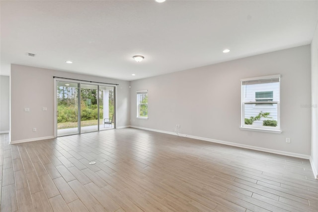 spare room with light wood-type flooring