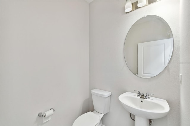 bathroom with toilet and sink