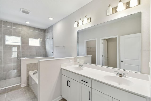 bathroom with vanity, tile patterned floors, and independent shower and bath