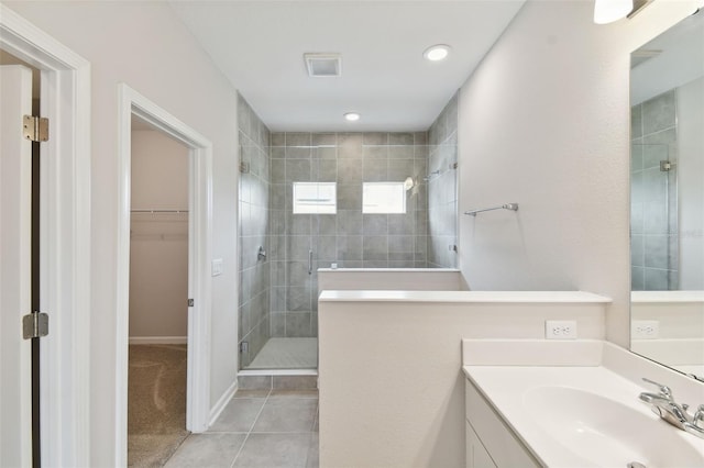 bathroom with vanity, an enclosed shower, and tile patterned flooring