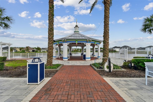 view of patio featuring a water view and a gazebo