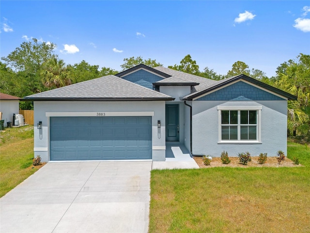3883 Dominic St, North Port, FL 34288 - ranch-style house with a garage, stucco siding, driveway, and a front lawn