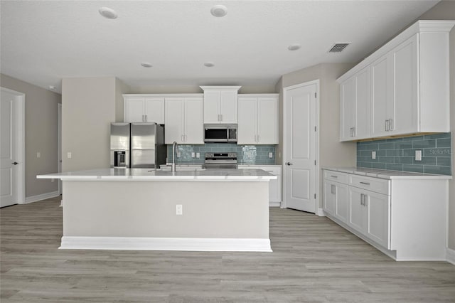 3883 Dominic St, North Port, FL 34288 - kitchen with visible vents, a sink, appliances with stainless steel finishes, and tasteful backsplash