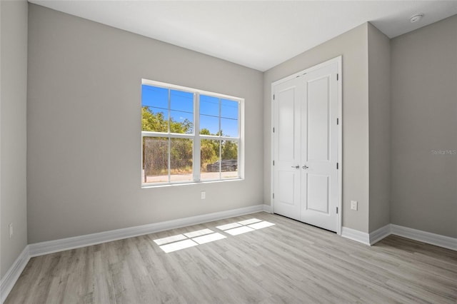 3883 Dominic St, North Port, FL 34288 - unfurnished bedroom with baseboards, light wood-style floors, and a closet