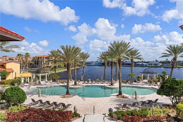 view of pool with a patio and a water view