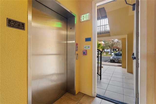 interior space featuring elevator and light tile patterned floors