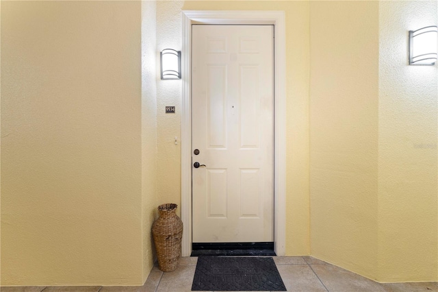 entryway with light tile patterned floors