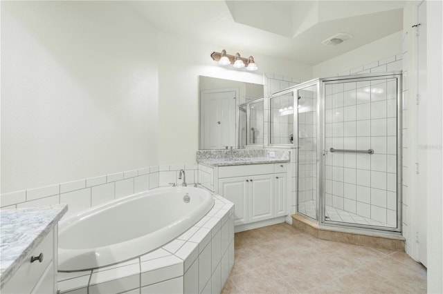 bathroom featuring tile patterned floors, vanity, and independent shower and bath