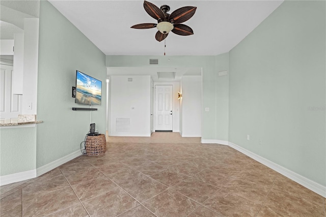 tiled spare room with ceiling fan