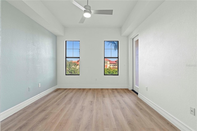 spare room with ceiling fan and light wood-type flooring