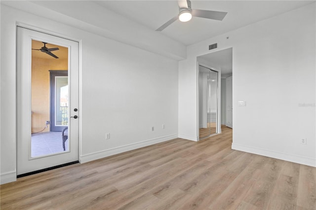 empty room featuring ceiling fan and light hardwood / wood-style floors