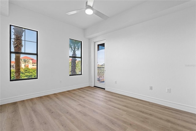 unfurnished room featuring plenty of natural light, light hardwood / wood-style floors, and ceiling fan