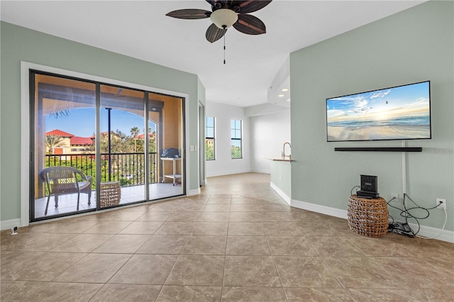 unfurnished living room with light tile patterned floors and ceiling fan