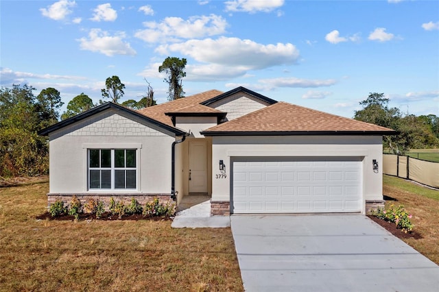 view of front of home with a front lawn and a garage