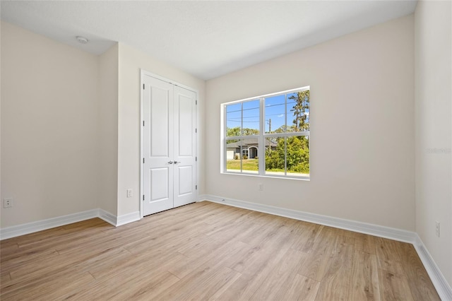 3779 Clearfield St, North Port, FL 34286 - unfurnished bedroom with light wood-type flooring, baseboards, and a closet