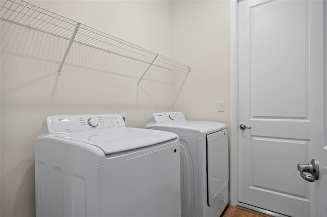 3779 Clearfield St, North Port, FL 34286 - laundry area featuring separate washer and dryer, laundry area, and light wood-type flooring