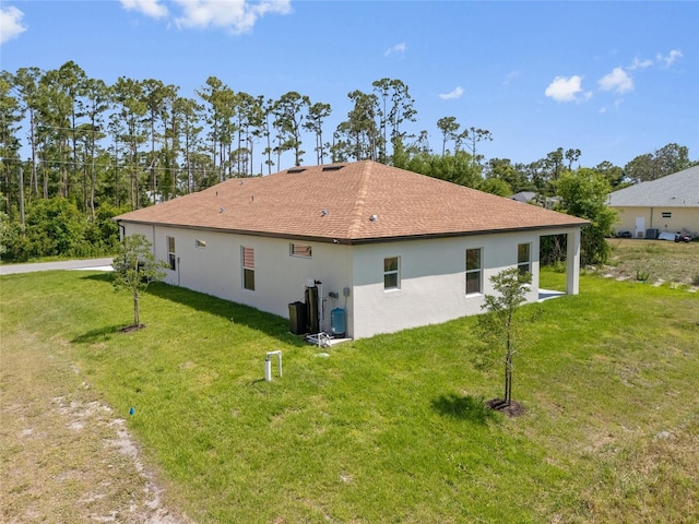 3779 Clearfield St, North Port, FL 34286 - back of house featuring a yard and stucco siding