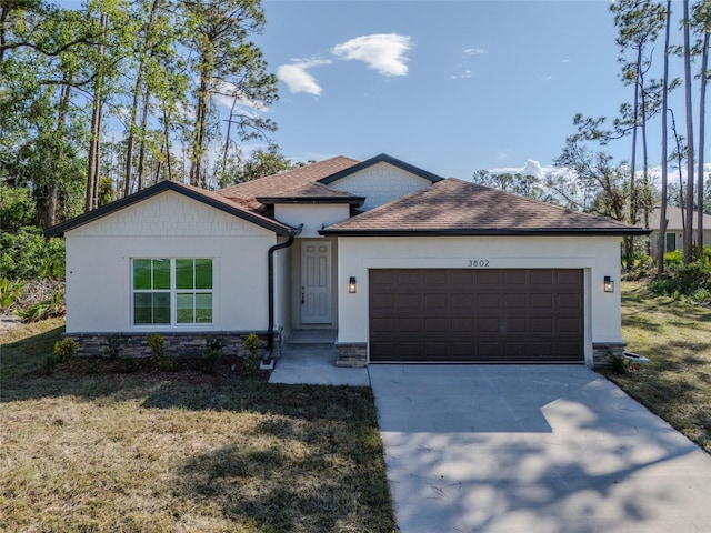 view of front of property with a garage and a front lawn