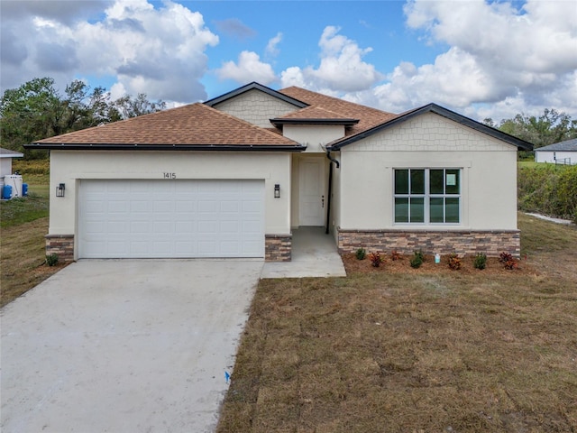 view of front of house featuring a garage and a front lawn