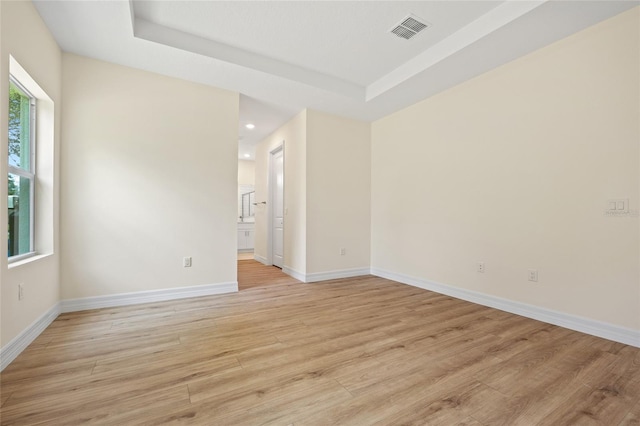 1415 Nackman Rd, North Port, FL 34288 - empty room featuring light wood-type flooring, a raised ceiling, baseboards, and recessed lighting