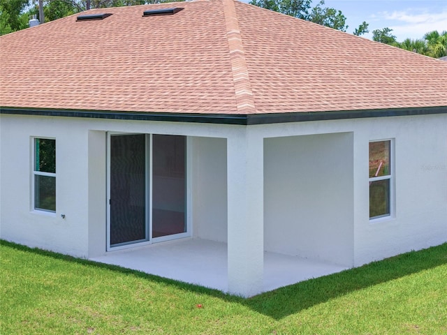1415 Nackman Rd, North Port, FL 34288 - back of property with roof with shingles, a patio area, and a yard