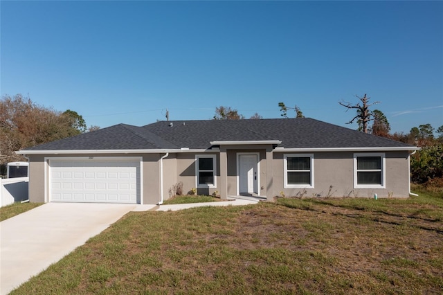 ranch-style home with a garage and a front lawn