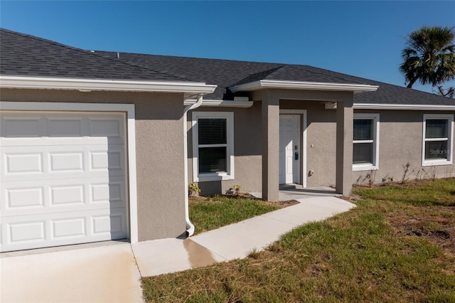 entrance to property with a garage and a yard