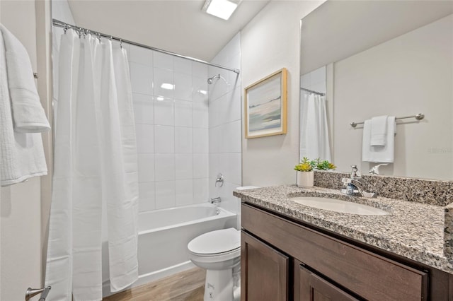 full bathroom with hardwood / wood-style floors, vanity, toilet, and shower / bathtub combination with curtain