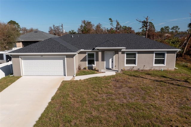 single story home featuring a garage and a front lawn