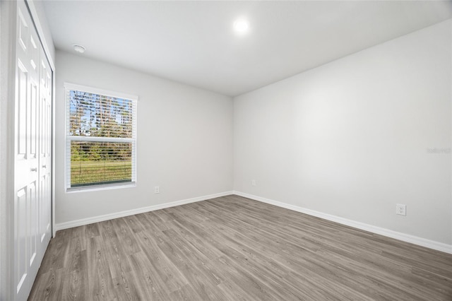 empty room with wood-type flooring