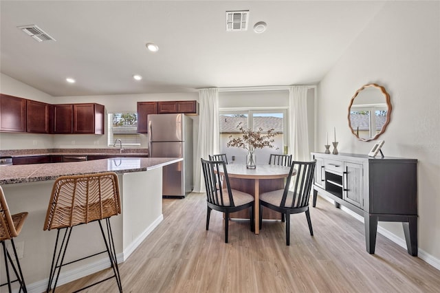 dining area featuring sink and light wood-type flooring