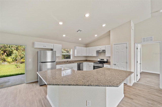 kitchen featuring stainless steel appliances, a kitchen island, white cabinetry, and light hardwood / wood-style floors