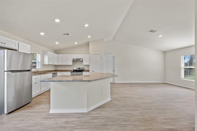 kitchen with white cabinets, a center island, stainless steel appliances, and plenty of natural light