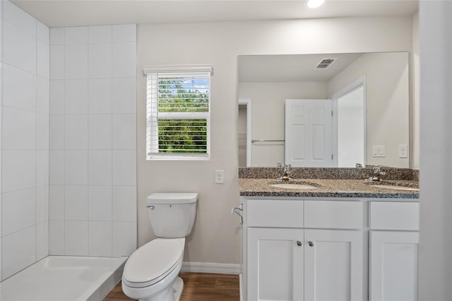 bathroom with wood-type flooring, vanity, and toilet