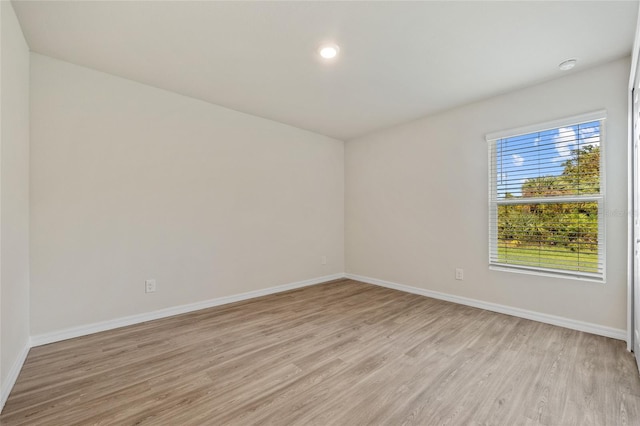 unfurnished room featuring light hardwood / wood-style flooring and plenty of natural light