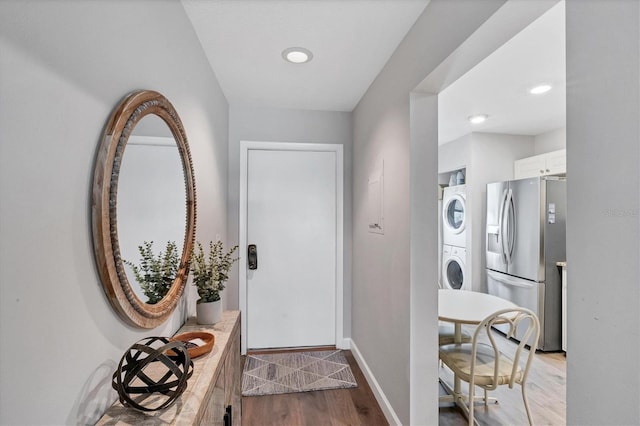 interior space featuring stacked washer and dryer and light wood-type flooring