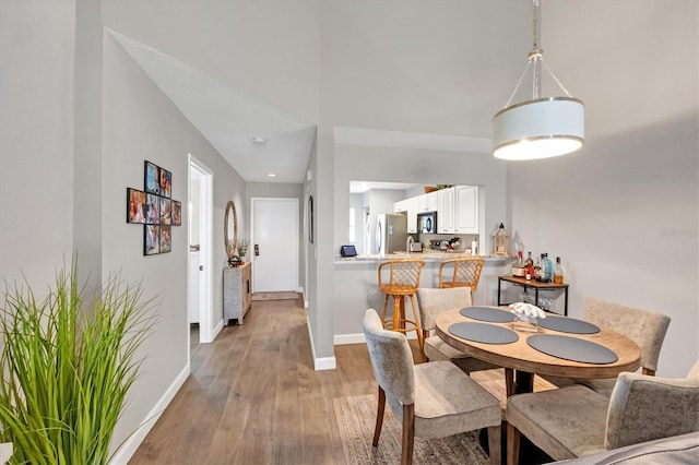 dining space with wood-type flooring