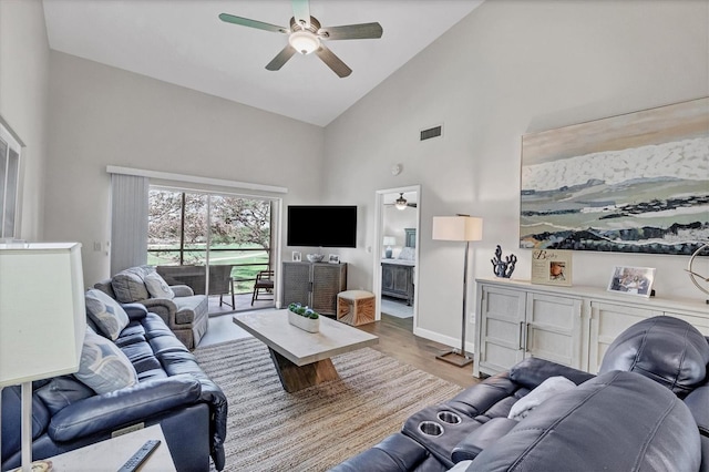 living room featuring light hardwood / wood-style floors, high vaulted ceiling, and ceiling fan