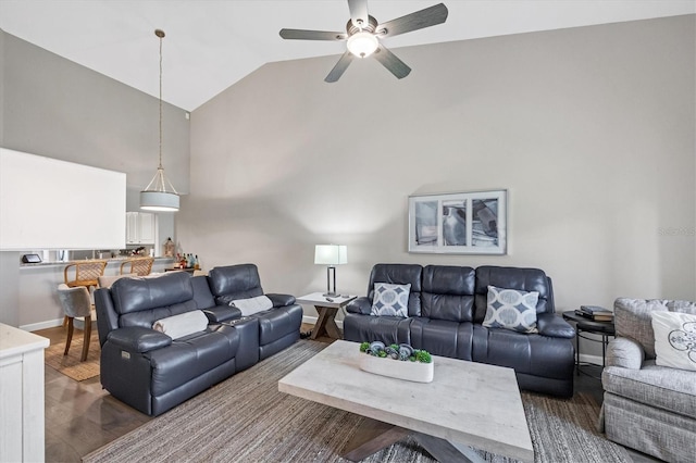 living room featuring ceiling fan, vaulted ceiling, and dark hardwood / wood-style floors