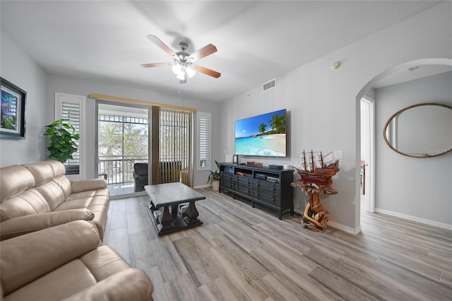 living room with light wood-type flooring and ceiling fan