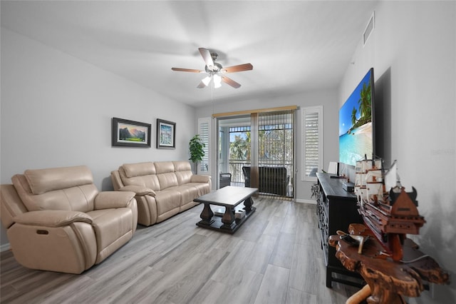 living room with hardwood / wood-style floors and ceiling fan