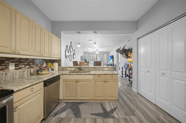 kitchen with light hardwood / wood-style floors, dishwasher, kitchen peninsula, sink, and decorative light fixtures