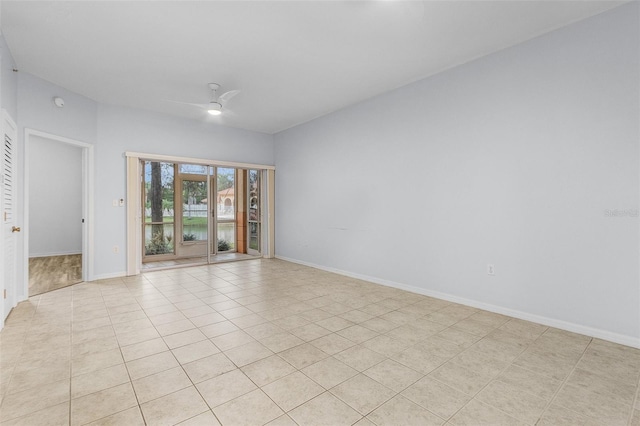 tiled empty room featuring ceiling fan